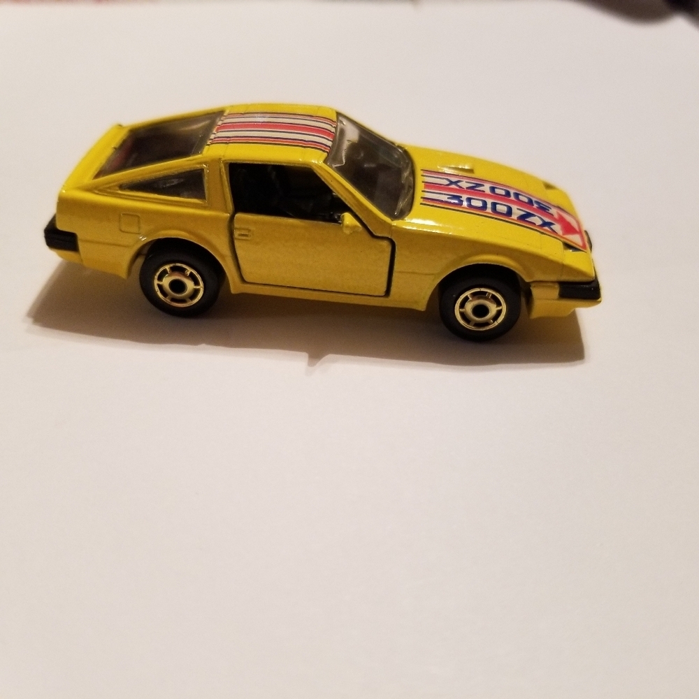 Yellow Nissan 300ZX With Blue,White And Red Stripe Detail Hot Wheels Diecast Car